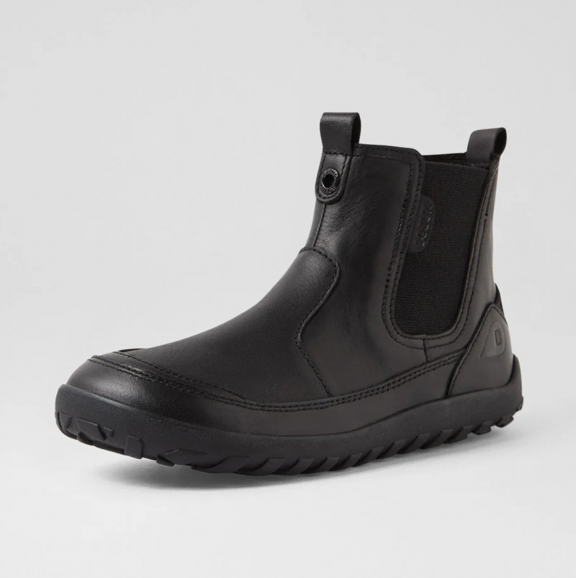A product listing screenshot for BOBUX Trail Kid Black ankle boots, showing a large photo of the boot on the left, smaller thumbnail views along the right, and product details including size options and a green size guide box.