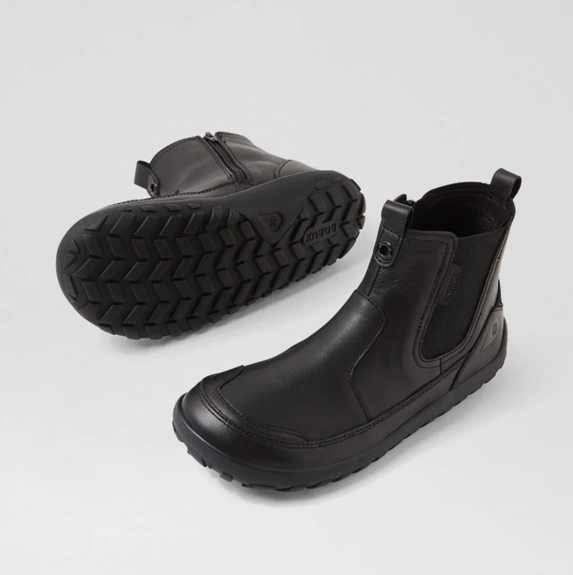 A product listing page for a pair of black BOXBUX Trail K14 kids' boots, showing a large product image, size selection, product description, and thumbnail previews on a white webpage layout.